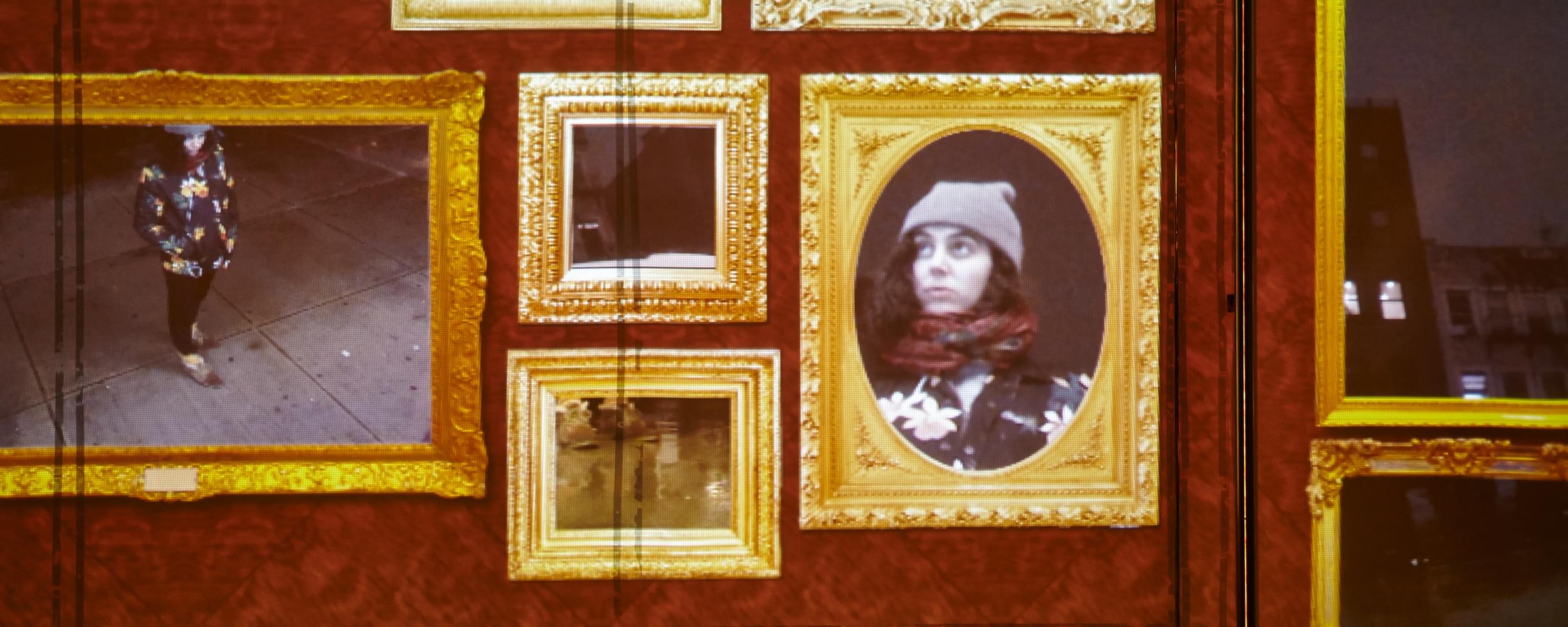 Close-up photograph showing a projected image of about 10 ornately decorated golden frames, Baroque style, where the contents of each frame is a slice of the external environment. For example, in the leftmost bottom frame shows a video of a person on the sidewalk from a top-down view, the leftmost upper frame shows a close-up of that person's sneakers, while a few frames over to the right shows a close-up of that viewer's face. The other 7 frames show different slices of the urban environment in which the viewer is in (apartment building windows in the background, a bus tire that's passing by on the street, etc.